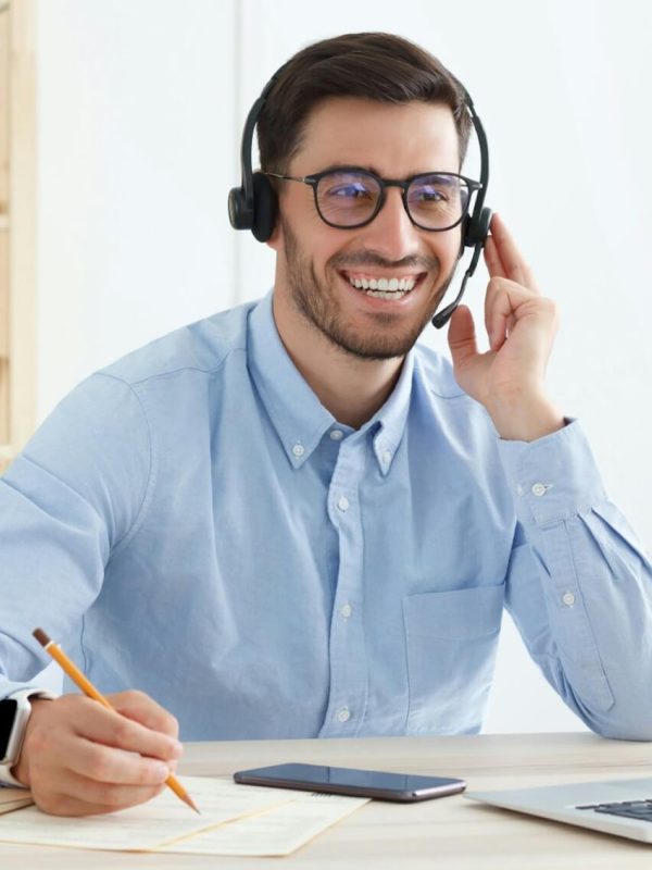smiling-customer-support-service-operator-with-hands-free-headset-working-in-office.jpg